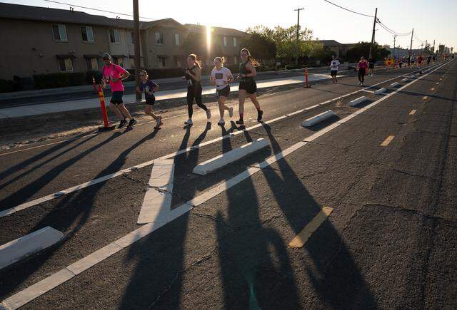 A group runs up Ninth Street during the Modesto Marathon in Modesto, Sunday, March 22, 2026. Runners competed in marathon, half marathon, 10K and 5K races.